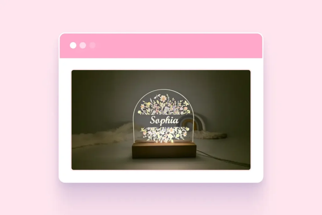 Personalized floral acrylic night light with the name “Sophia” illuminated on a wooden base in a dimly lit room.