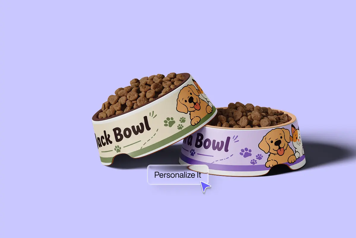 Two personalized pet food bowls, green and purple, printed with cartoon puppy and cat illustrations and filled with kibble. A "Personalize It" tooltip with cursor appears between them