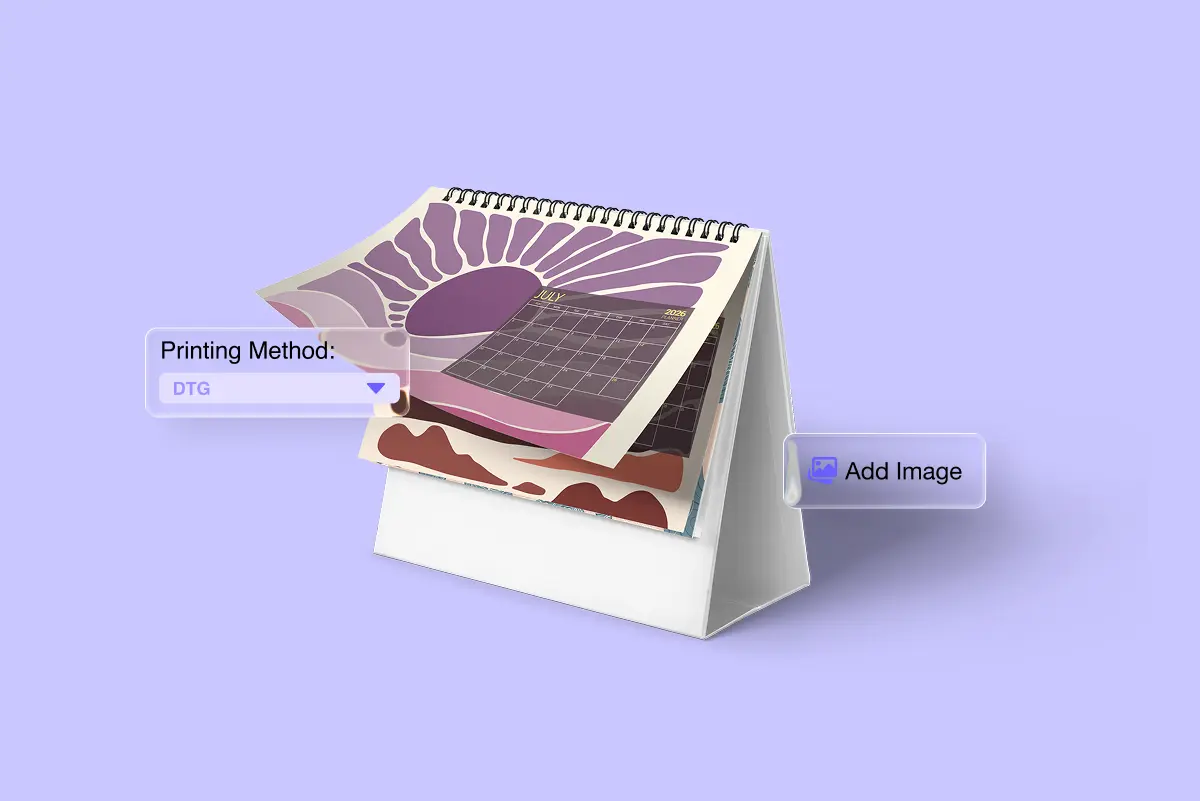 Spiral-bound desk calendar open to a July 2026 grid page, layered pages below showing purple sunburst and brown wave patterns. "Printing Method: DTG" and "Add Image" labels appear beside the calendar