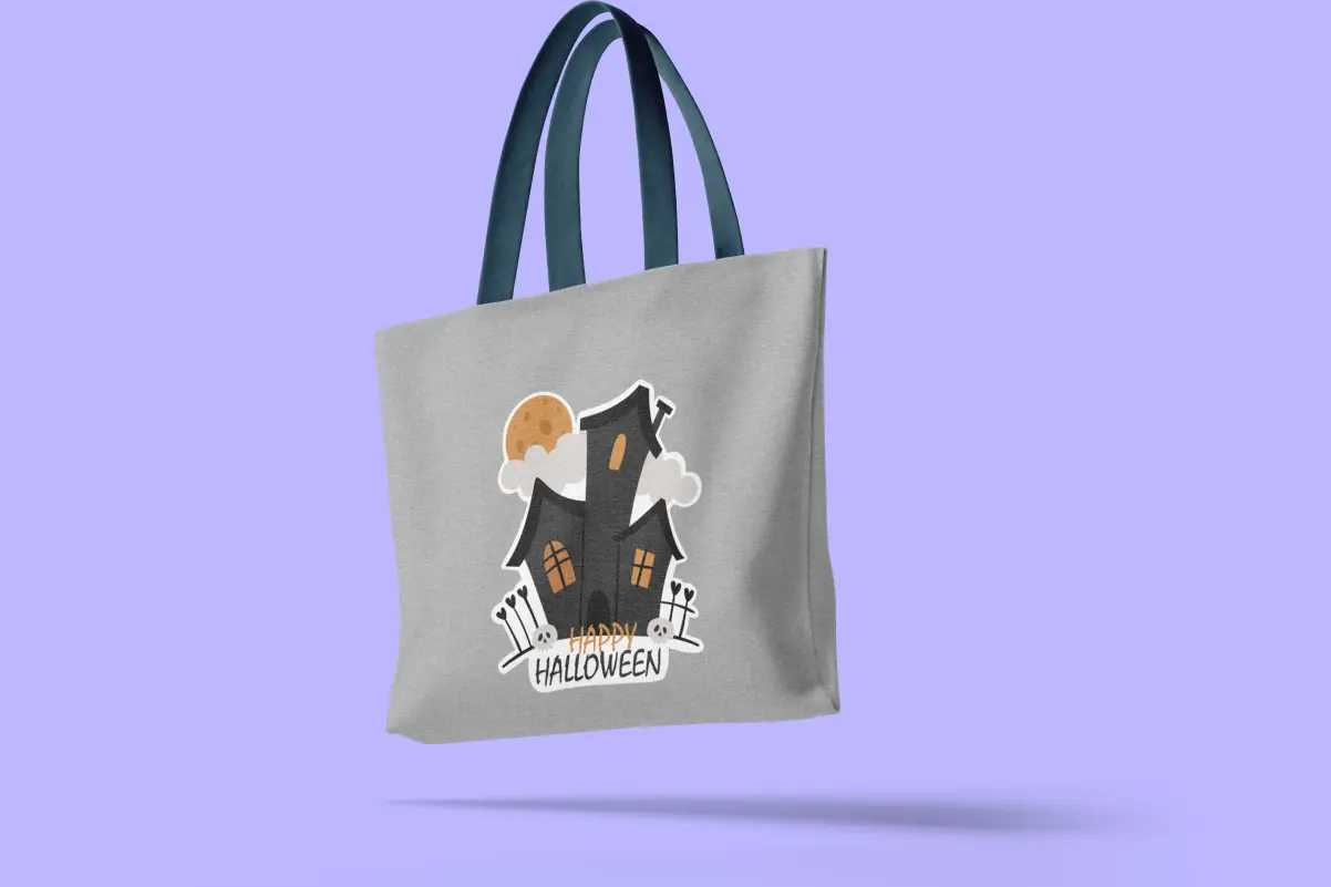 Personalized canvas Halloween tote bag with a haunted house and “Happy Halloween” design
