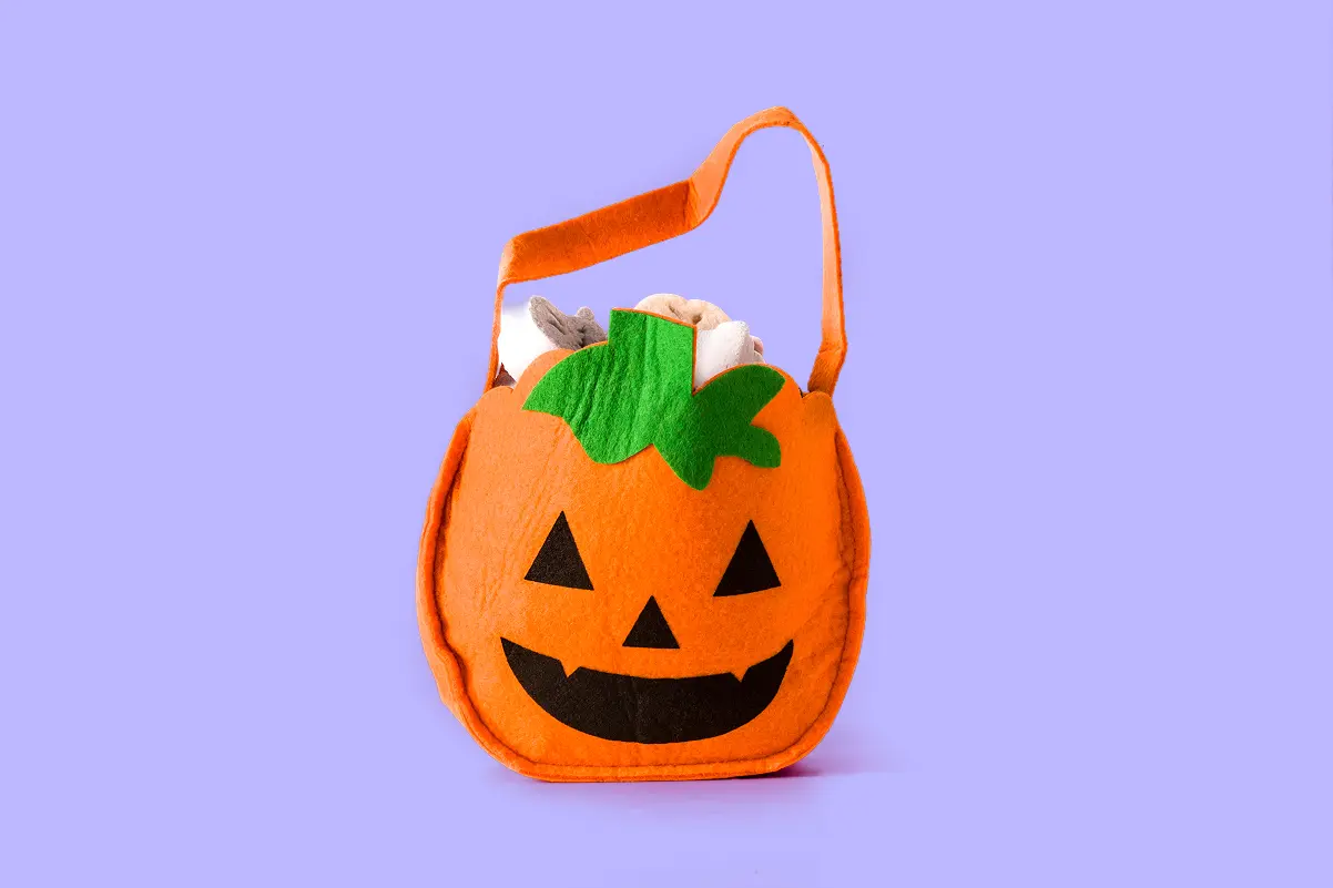 Custom Halloween pumpkin treat bag with a jack-o’-lantern design and orange handles